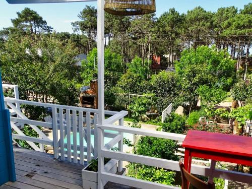 a balcony with a table and a view of a garden at Il Tano Suites in Punta Del Diablo