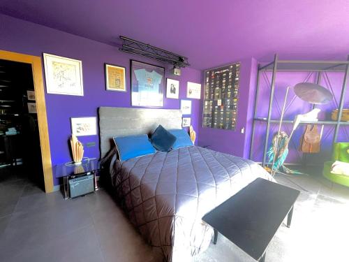 a purple bedroom with a bed and a purple wall at Marbella Boutique Art suites in Marbella