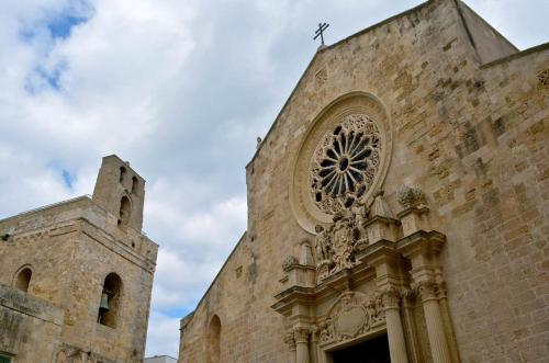 a church with a cross on the top of it at La Ozza B&B in Otranto