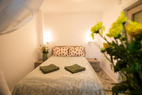 a bedroom with a bed with two green pillows at Marc's SELF CHECK-IN with free parking in Oradea