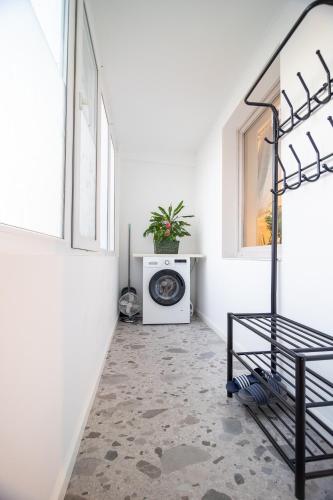 a hallway with a white room with a laundry machine at Marc's SELF CHECK-IN with free parking in Oradea