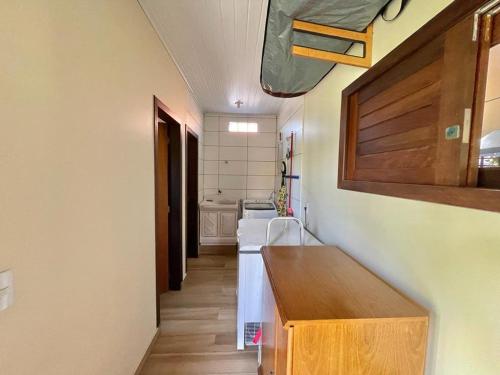 a kitchen with a sink and a stove top oven at Linda casa frente a lagoa! in Laguna