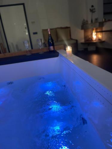 a bath tub with blue lights in a living room at Nakupenda Relais in Latina