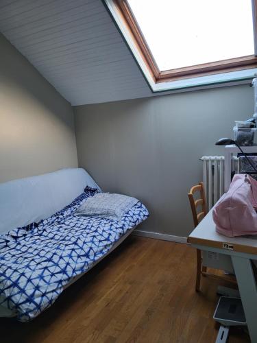 a small bedroom with a bed and a window at Maison JO 2024 in Guyancourt