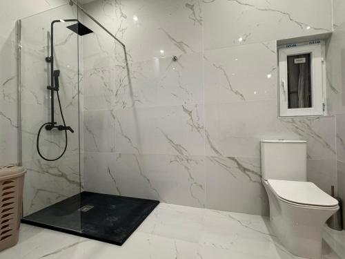 a bathroom with a shower and a toilet at One in Se7en in St. Julianʼs