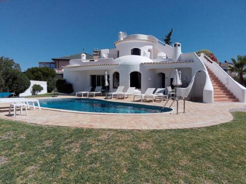 a house with a swimming pool in front of it at Casa Francisco : Family Villa with private pool. Near to beach in Albufeira