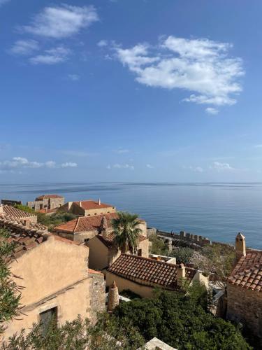 a view of a village with the ocean in the background at Ritsos Family Apartment in Monemvasia