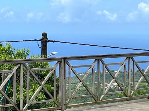 a bird sitting on a wooden bridge at Ti Kay Bonè Bellefontaine in Fond Belle Fontaine