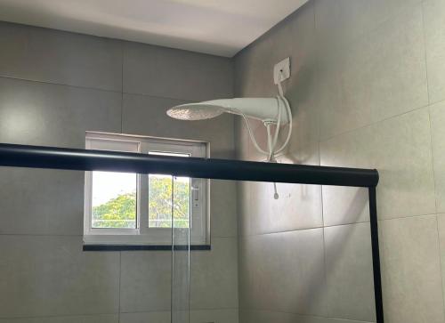 a shower in a bathroom with a window at Hotel 7 Quedas in Guaíra