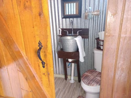 a bathroom with a sink and a toilet at Cabin by the Pool 