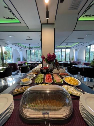 a table with many different types of food on it at Garden Boutique Hotel in Elbasan