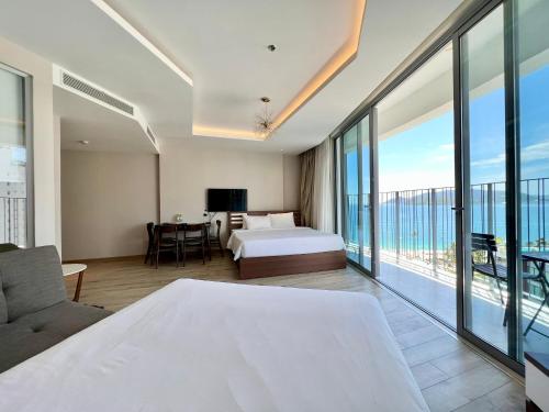 a bedroom with a bed and a view of the ocean at Panorama Nha Trang Inn in Nha Trang