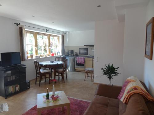 a living room with a couch and a table at Ferienwohnung Frühauf in Prien am Chiemsee