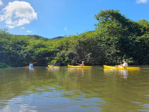 a group of people in kayaks in the water at JADE - Villa Créole de Standing et de charme ,vue mer , proche des plages & piscine privée haut de gamme in Saint-François