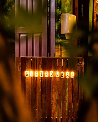 a sign that says bergdorff bar on a wooden fence at Pousada Ocazum in Alter do Chao