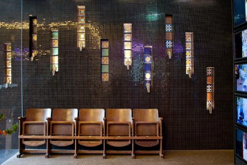 a group of chairs lined up against a wall at Nala Individuellhotel in Innsbruck