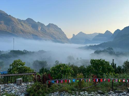 a view of a misty valley with mountains in the background at Tày Cốc Pảng Homestay in Làng Cac