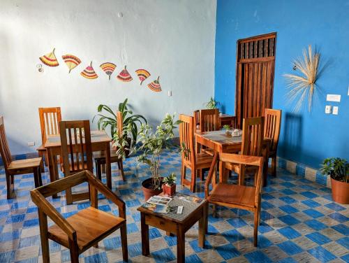 a dining room with wooden tables and chairs at Casa Aguazul in Campeche