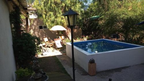a large swimming pool next to a street light at Monoambiente Golondrina in Capilla del Monte