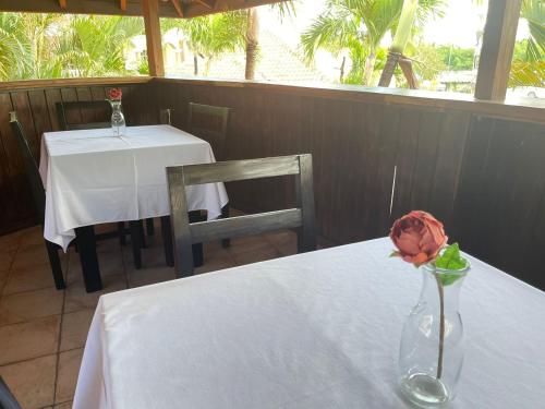a table with a vase with a flower on it at Hotel Brisa in Punta Cana
