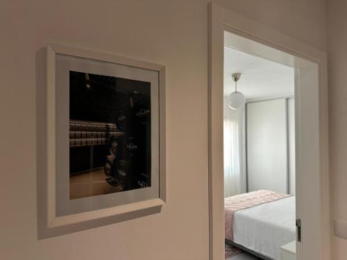a mirror on a wall next to a bedroom at Marinho's Oporto Apartments II in Porto