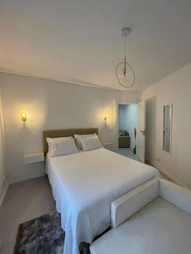 a bedroom with a large bed with white sheets at Marinho's Oporto Apartments II in Porto