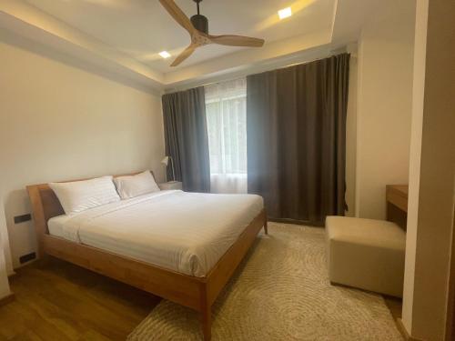 a bedroom with a bed and a ceiling fan at kamala hills estate A102 in Kamala Beach