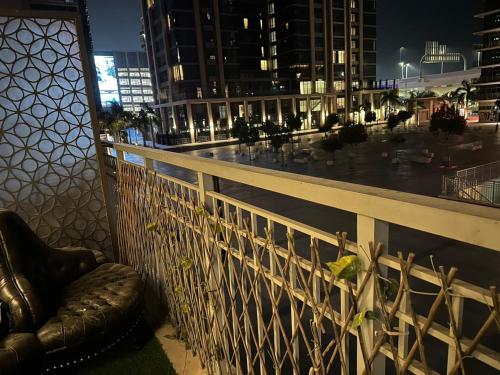 a chair on a balcony with a view of a city at Sherina Plaza 2 Flat 103 in Dubai