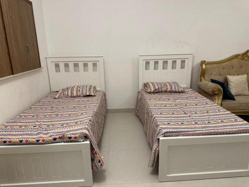 Postel nebo postele na pokoji v ubytování Sherina Plaza 2 Flat 103