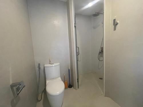 a bathroom with a toilet and a shower at kamala hills estate A102 in Kamala Beach
