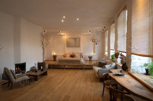 a large living room with a bed and a couch at n o c t u r n e in Kamianets-Podilskyi