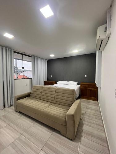 1 dormitorio con cama grande y ventana grande en Hotel Backdoor, en Imbituba