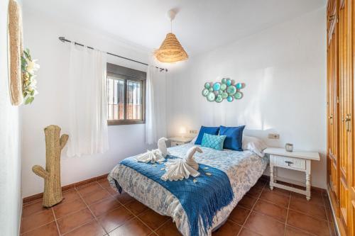 een slaapkamer met een bed met twee zwanen erop bij la casa del bosque in Júzcar