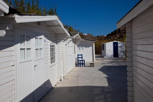 a row of white garages in a row at Paradise Beach Camping - Adults Only in Paradise Beach