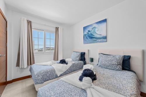 a bedroom with two beds with stuffed animals on them at Villa Atlántica - Heated pool in Playa Blanca in Playa Blanca