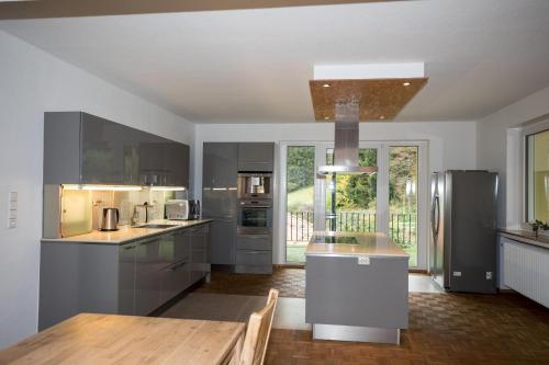 a large kitchen with a wooden table in it at Ferienhaus Lacher in Baiersbronn