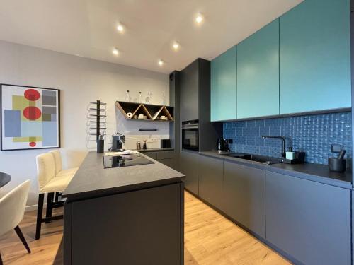 a kitchen with blue cabinets and a counter top at River Paradise with Parking Spot in Wrocław
