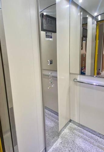 a hallway with a glass door to a elevator at Ático Puerto Mar in O Pindo