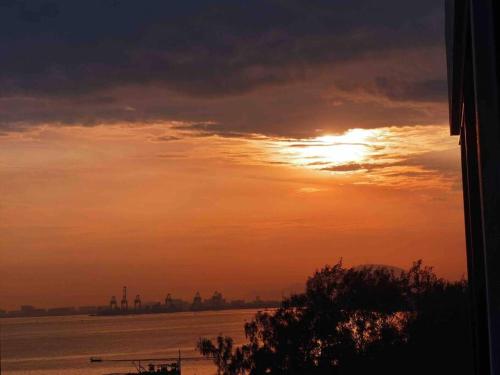 a sunset over a body of water with at [NEW LAUNCH] SUNRISE GURNEY SEAVIEW'63 无敌日出海景63 in George Town