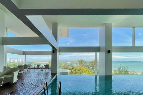 a house with a swimming pool with a view of the ocean at [NEW LAUNCH] SUNRISE GURNEY SEAVIEW'63 无敌日出海景63 in George Town