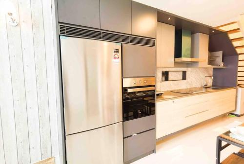 a kitchen with a large stainless steel refrigerator at [NEW LAUNCH] SUNRISE GURNEY SEAVIEW'63 无敌日出海景63 in George Town