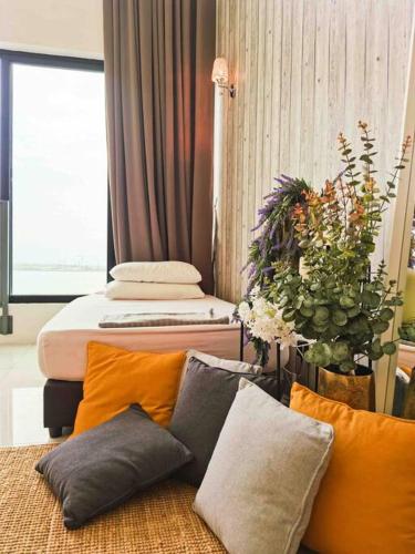 a room with two beds and a couch with pillows at [NEW LAUNCH] SUNRISE GURNEY SEAVIEW'63 无敌日出海景63 in George Town