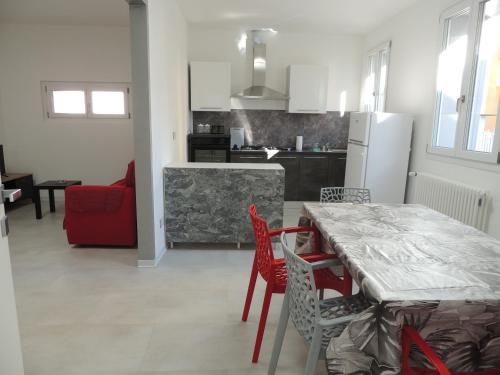 a kitchen and dining room with a table and chairs at Casa Cortina in Domodossola