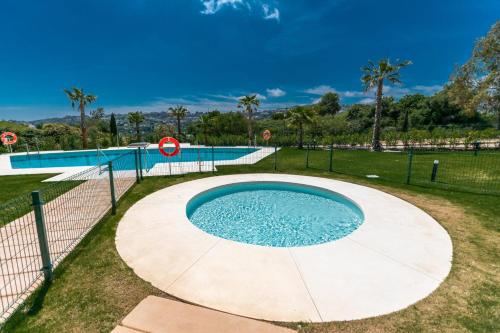 a swimming pool next to a tennis court at Luxury La Cala Golf Haven with terrace & pool in La Cala de Mijas