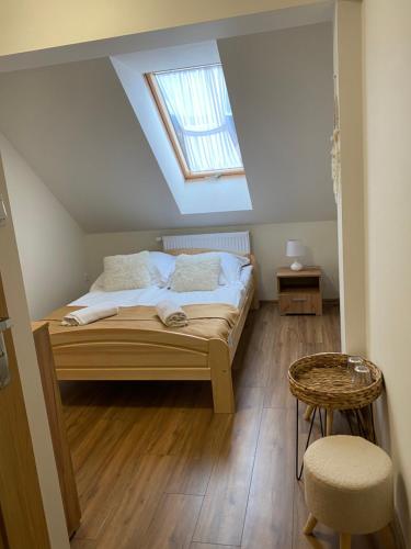 a bedroom with a bed and a skylight at Willa Wioletta in Tylmanowa