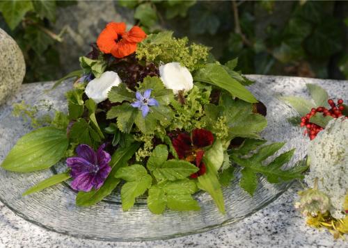 a bouquet of colorful flowers on a plate at Hotel Forstmeister in Schönheide