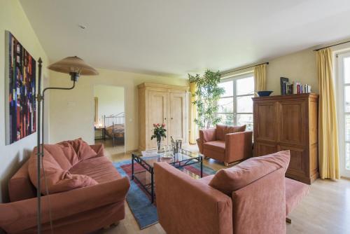 a living room with two couches and two chairs at ArtVilla am See - offen März bis Ende Oktober in Radolfzell am Bodensee