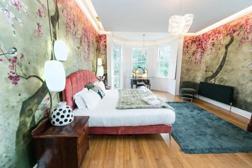 a bedroom with a bed and floral wallpaper at Hillthorpe Manor by Maison Parfaite - Large Country House with Hot Tub in Pontefract