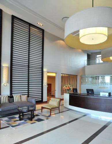 a lobby of a hotel with a couch and chairs at Cresta Mahalapye Hotel in Mahalapye