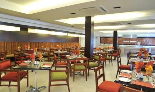 a restaurant with tables and chairs in a room at Cresta Mahalapye Hotel in Mahalapye
